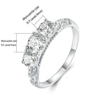 Silver ring with three diamonds and size measurements on a white background