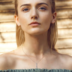 Close-up of a woman wearing a necklace with a blurred background