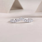 Silver ring with diamonds on a light beige background