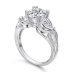Diamond ring with a central gemstone and two smaller stones on a white background
