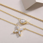 Gold necklace with diamond pendants on a light beige background