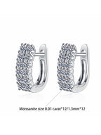 Silver hoop earrings with embedded stones on a white background