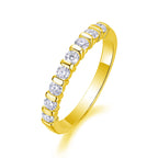 Gold ring with clear gemstones on a white background