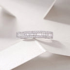 Diamond ring with baguette and round cut stones on a light background
