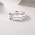 Silver ring with diamond accents on a light gray background