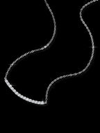 Silver chain necklace on a black background
