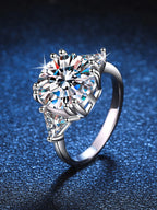 Silver ring with a large diamond on a dark blue background