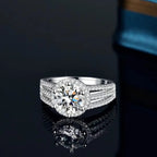 Silver ring with a large diamond on a reflective black surface