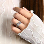 Close-up of a hand wearing a diamond ring with a white glove