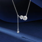 Silver necklace with a pendant on a dark blue background