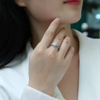 Close-up of a hand wearing a ring with a blurred background