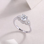 Silver ring with a diamond on a light pink background