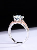 Rose gold and silver ring with a large diamond on a black background