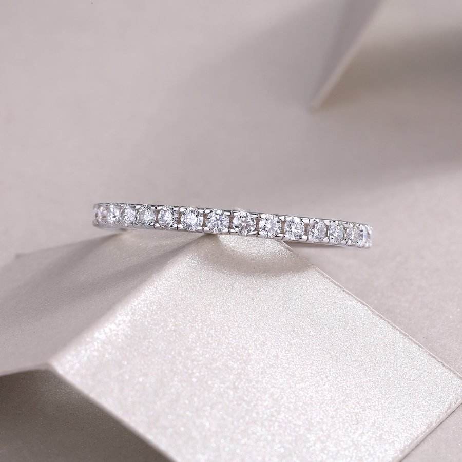 Diamond ring on a soft pink fabric background