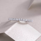 Diamond ring on a soft pink fabric background