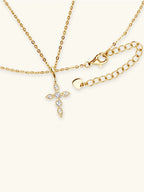 Gold necklaces with a cross pendant and another design on a white background