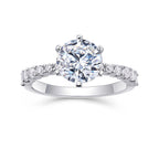 Diamond ring with a large central gemstone and smaller stones on a white background