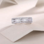 Two diamond wedding bands on a soft beige fabric background
