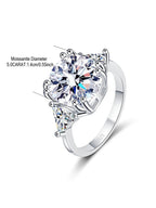 Silver ring with heart-shaped and triangle-shaped gemstones on a white background