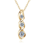 Gold necklace with three circular gemstones on a white background