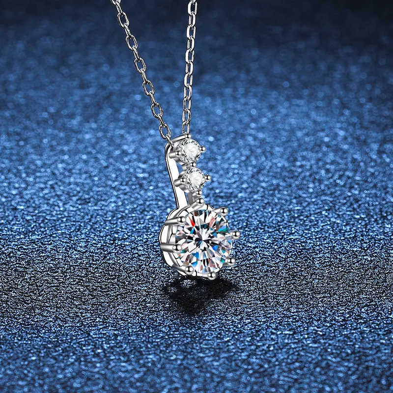 Silver necklace with a diamond pendant on a blue textured background
