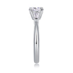 Silver ring with a clear gemstone on a white background