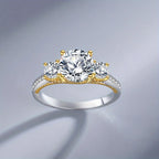 Gold and silver ring with three diamonds on a gray background