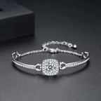 Silver bracelet with a central gemstone on a dark background
