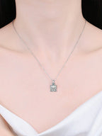 Silver necklace with a pendant on a model against a neutral background