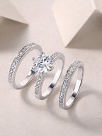 Two silver rings with diamond accents on a light background