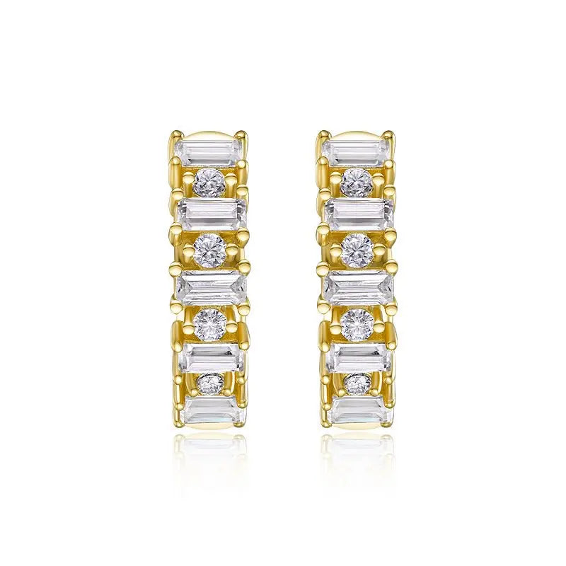 Gold and silver hoop earrings with clear gemstones on a white background
