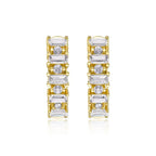 Gold and silver hoop earrings with clear gemstones on a white background