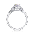 Silver ring with a large central gemstone and smaller stones on a white background