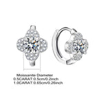 Silver earrings with clear gemstones on a white background
