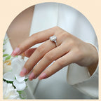 Hand wearing a diamond ring with a soft focus background