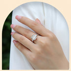 Hand wearing a diamond ring on a white background