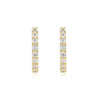 Gold hoop earrings with clear gemstones on a white background