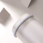 Silver bracelet with clear stones on a neutral background