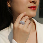 Close-up of a woman's hand wearing a silver ring with a blurred background