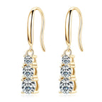 Gold earrings with clear gemstones on a white background