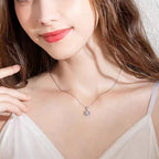 Woman wearing a delicate necklace with a small pendant