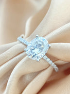 Diamond ring on a hand with a soft beige background