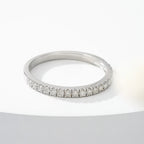 Silver ring with small diamonds on a white background