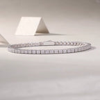 Silver bracelet with diamond accents on a light gray background