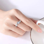 Silver ring with a diamond on a hand against a white background