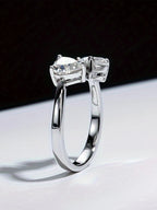 Silver ring with two diamonds on a black and white background
