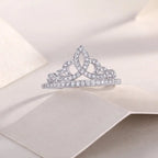 Silver tiara with clear stones on a soft beige background