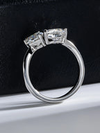 Silver ring with two large diamonds on a black background