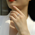 Close-up of a hand wearing a ring with a blurred background