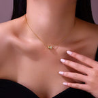 Gold necklace with a small round pendant on a person's neck